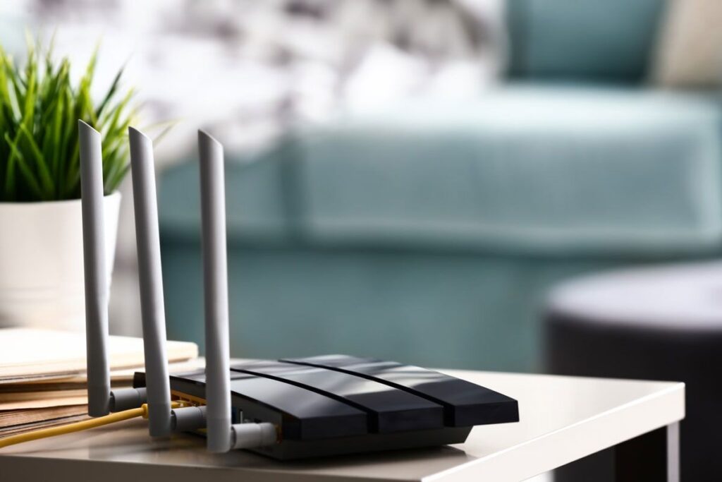 D-Link users beware: Hackers are looking for end-of-life models to exploit Wi-Fi router plugged in on a side table at home