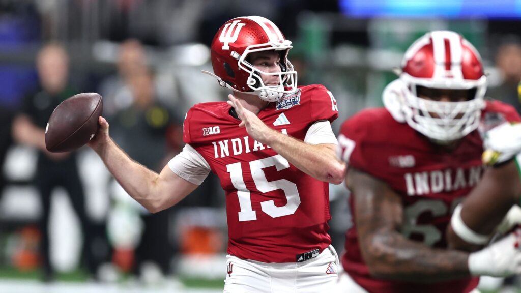 Watch College Football National Championship 2026 Fernando Mendoza of the Indiana Hoosiers attempts a pass during a College Football Playoff game.