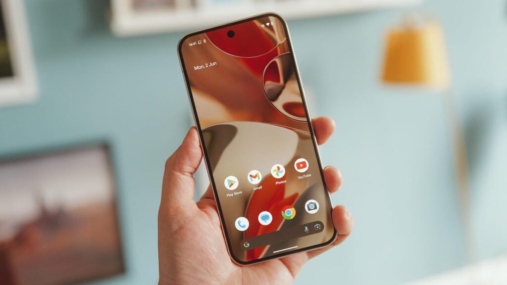 Image of a hand holding a phone with the screen turned on.