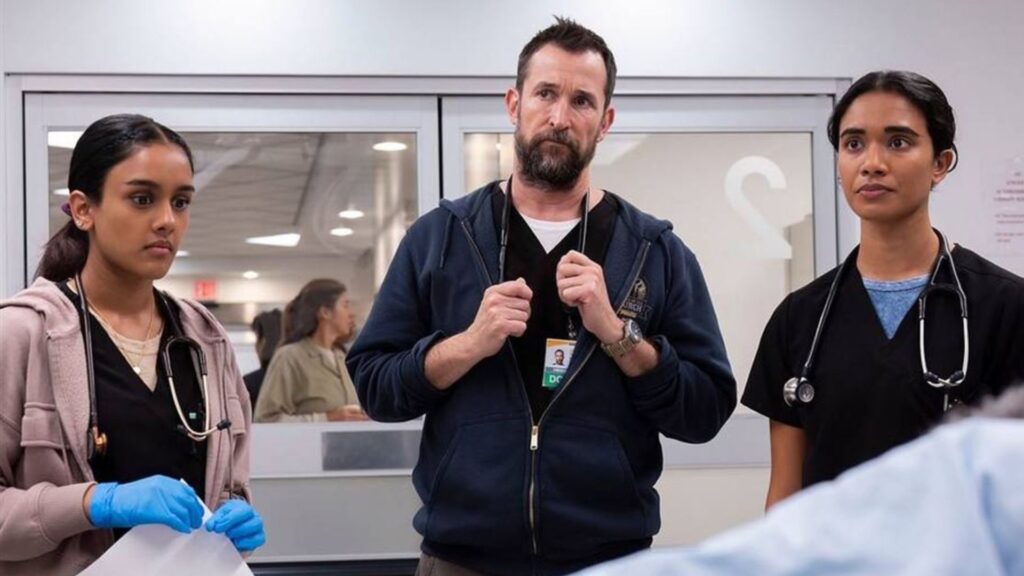 Three doctors stand in a surgery room