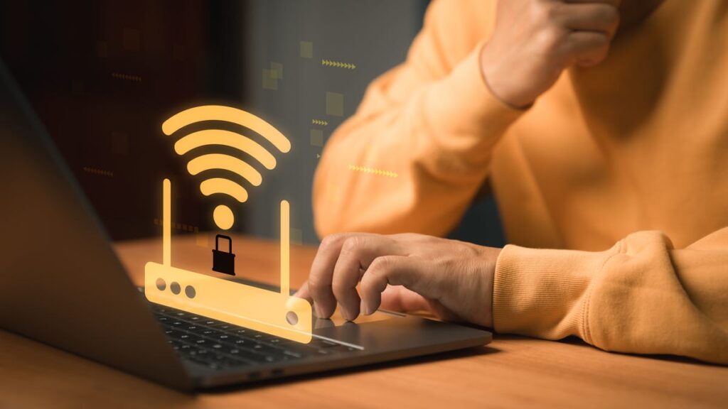 Cybersecurity and WiFi protection concept. WiFi router with a lock symbol appears above a laptop, representing secure internet