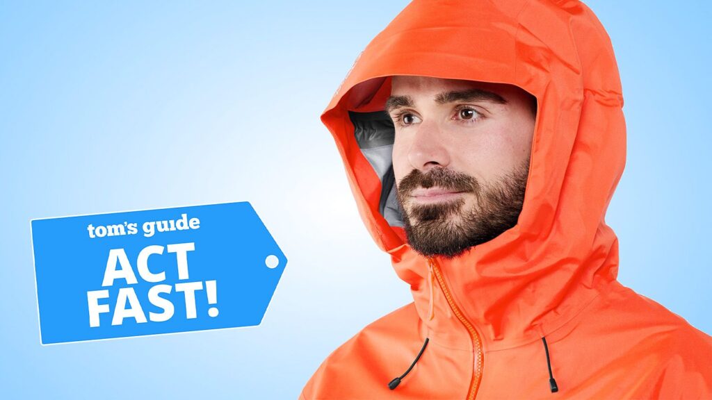 I walk 10,000 steps daily, rain or shine — these are the 3 jackets I swear by for conquering spring weather Close-up of a model wearing the Arc'teryx Beta SL rain jacket in orange