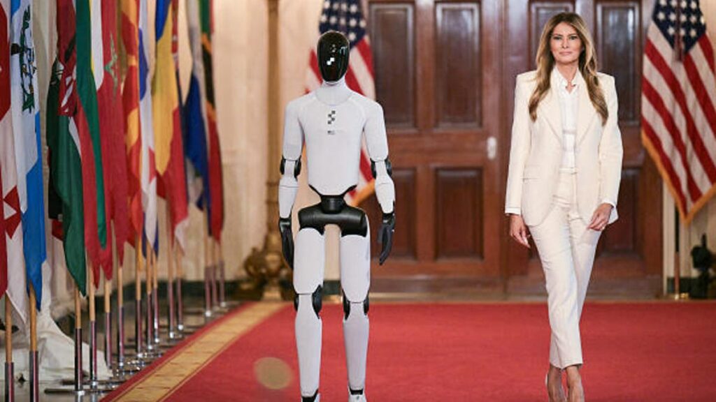 Melania Trump Escorted by Talking Humanoid Robot at White House Tech Summit First Lady Melania Trump walking on the red carpet with Figure 03 humanoid robot