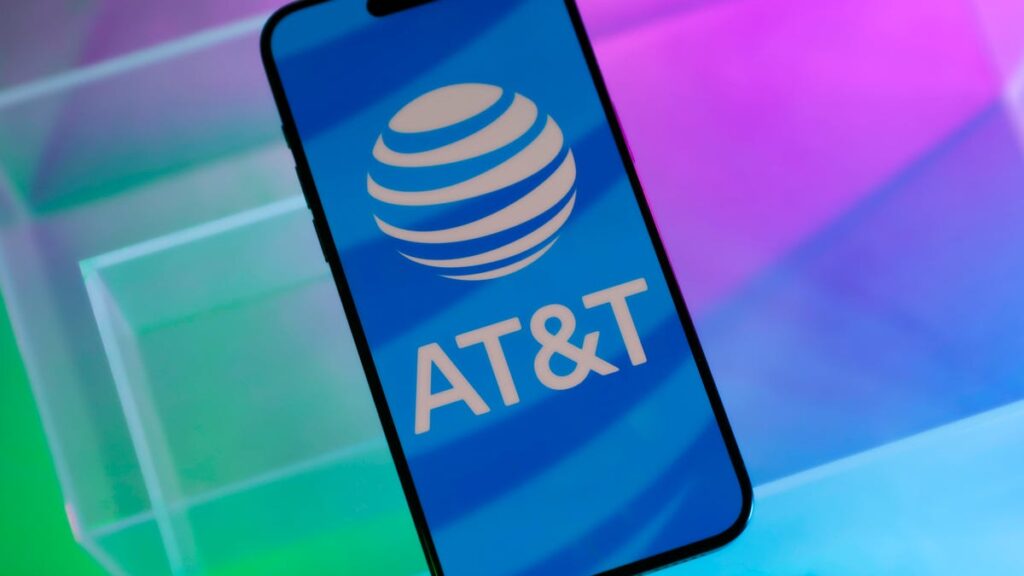 AT&T Rumored to Launch New Top-Tier Unlimited Phone Plan Soon AT&T logo on a phone