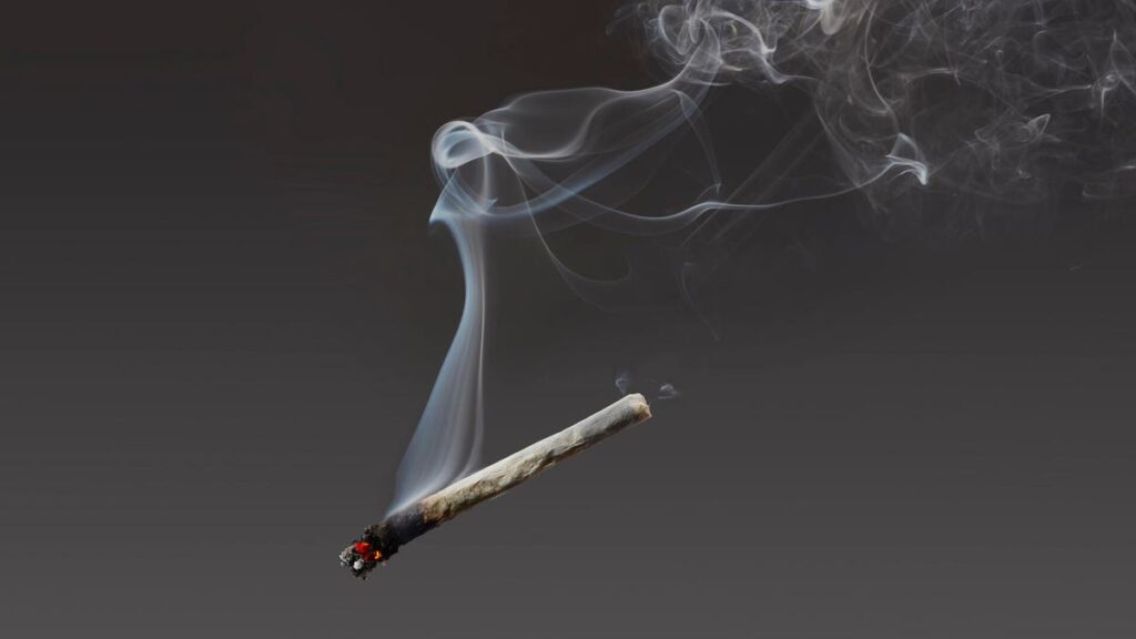 marijuana cigarette suspended in air with smoke wafting
