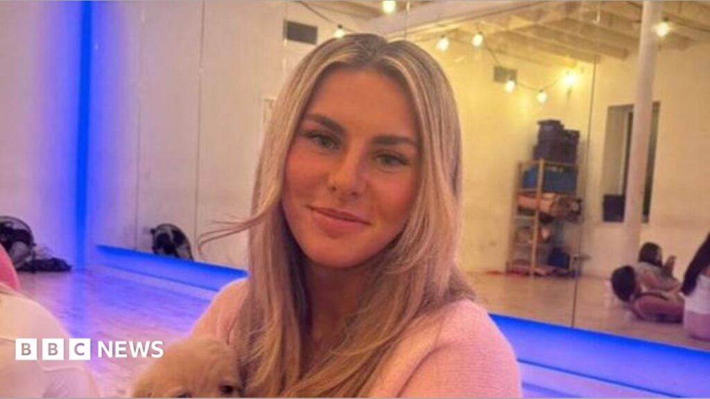 GPs to offer two new tests to help spot endometriosis Ami Robertson sits in a Pilates studio. She is holding a dog on her lap and is smiling at the camera. She has long blonde hair.