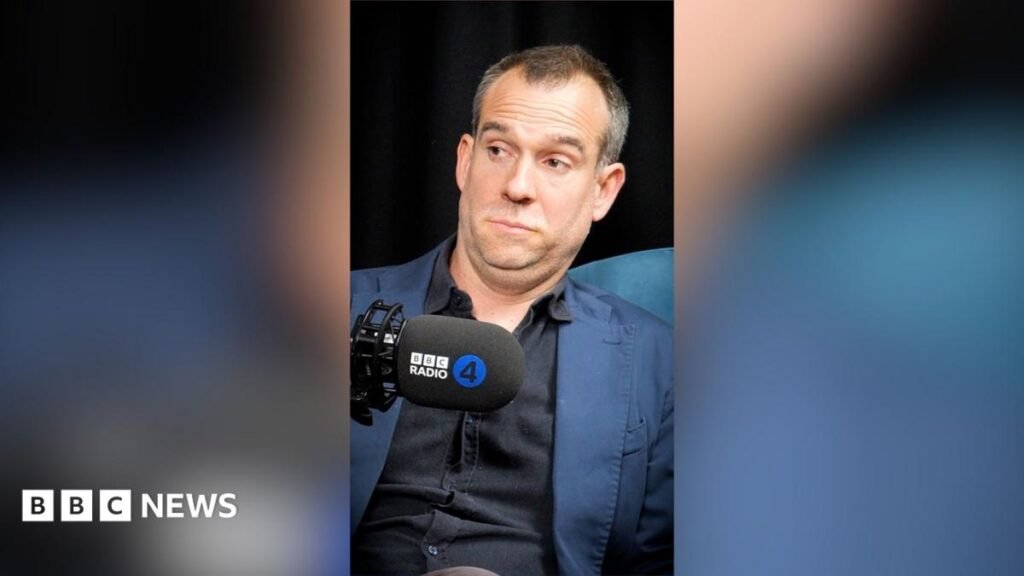 How to spot a liar A man with short grey hair wearing a black shirt and blue blazer raises his eyebrows at someone off-camera