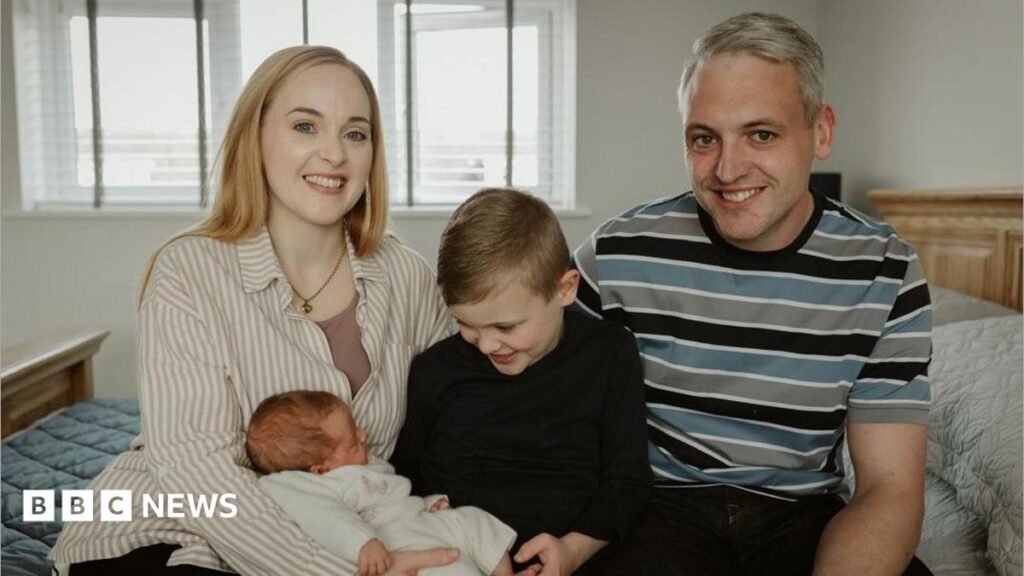 Mum wants people to know ‘there is hope after pregnancy loss’ Hayley and Mike with their children George and Hope. The family are sitting on a bed and are smiling at the camera.