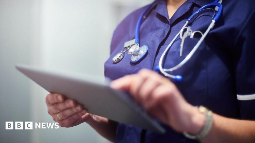 Stock image of a nurse holding a tablet computer presumably containing medical records.