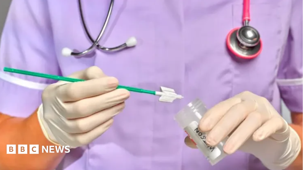 NHS to roll out at-home HPV cervical screenings in Wolverhampton A medic, pictured from the shoulders to waist wearing purple scrubs, with a stethoscope around their neck, wearing white gloves and holding a sample tube.