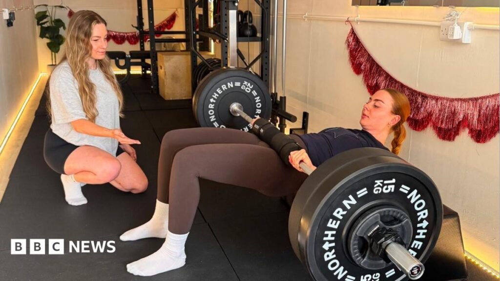 Cordelia exercises her arm muscles using hand-held weights